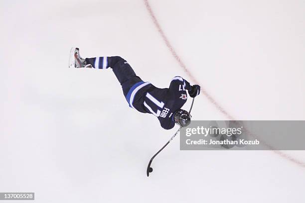 Eric Fehr of the Winnipeg Jets takes a shot during the pre-game warm up prior to facing the New Jersey Devils at the MTS Centre on January 14, 2012...