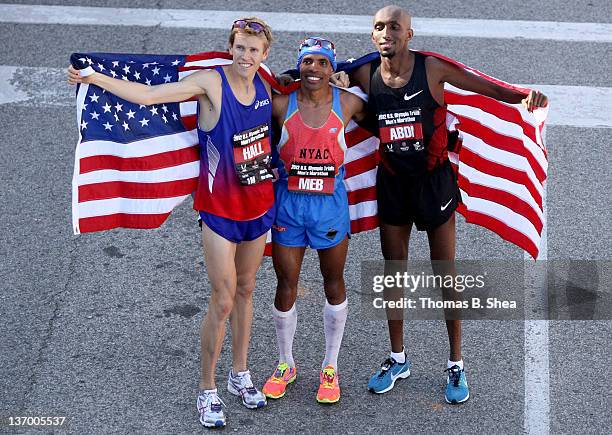 Ryan Hall, Meb Keflezighi and Abdi Abdirahman celebrate holding the American flag after they competed in the U.S. Marathon Olympic Trials January 14,...