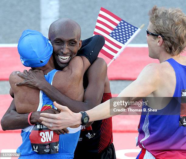 Meb Keflezighi, Abdi Abdirahman and Ryan Hall celebrate after they finish the U.S. Marathon Olympic Trials January 14, 2012 in Houston, Texas.