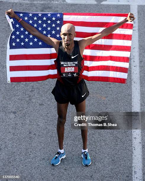 Abdi Abdirahman who finished with a time of 2:09:47 celebrates holding the American Flag as he poses after competing in the U.S. Marathon Olympic...