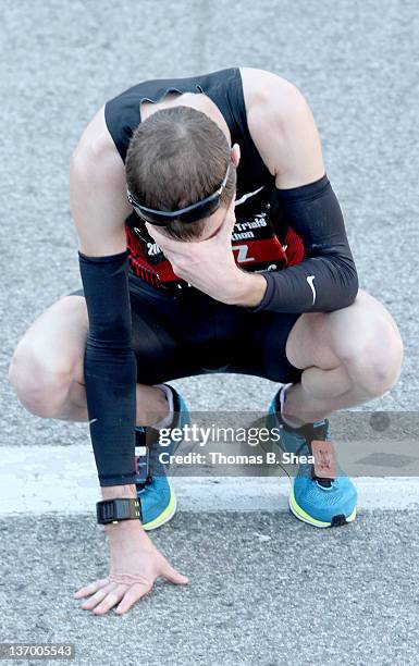 Dathan Ritzenhein, with a time of 2:09:55, drops to the ground after finishing fourth in the U.S. Marathon Olympic Trials January 14, 2012 in...