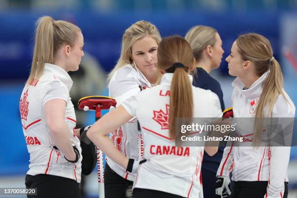 Dawn McEwen, left, Jennifer Jones, Kaitlyn Lawes and Jocelyn Peterman, right, of Team Canada huddle before a match against Team Sweden during the...