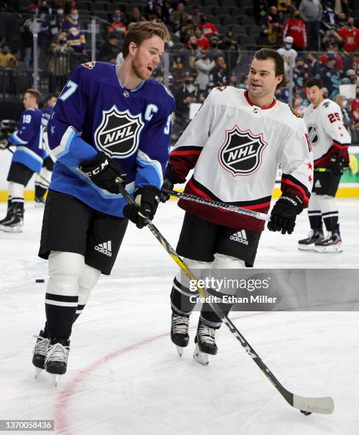 Connor McDavid of the Edmonton Oilers and Alex DeBrincat of the Chicago Blackhawks warm up before the 2022 Honda NHL All-Star Game at T-Mobile Arena...