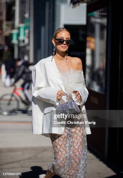 Leonie Hanne seen wearing sheer skirt, white blazer, silver Balenciaga bag, white top outside Bronx & Branco during New York Fashion Week on February...