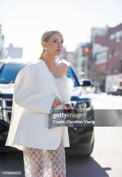 Leonie Hanne seen wearing sheer skirt, white blazer, silver Balenciaga bag, white top outside Bronx & Branco during New York Fashion Week on February...