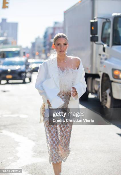 Leonie Hanne seen wearing sheer skirt, white blazer, silver Balenciaga bag, white top outside Bronx & Branco during New York Fashion Week on February...