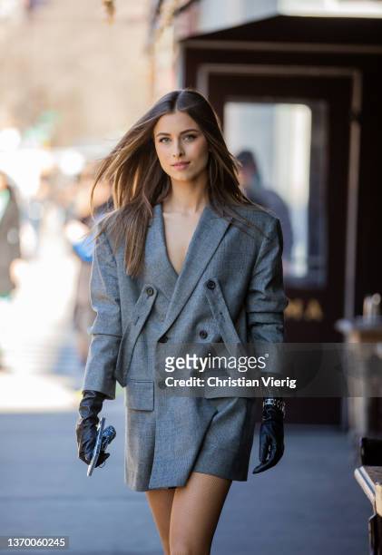 Guest is seen wearing grey blazer, black gloves, Rolex watch outside Bronx & Branco during New York Fashion Week on February 11, 2022 in New York...