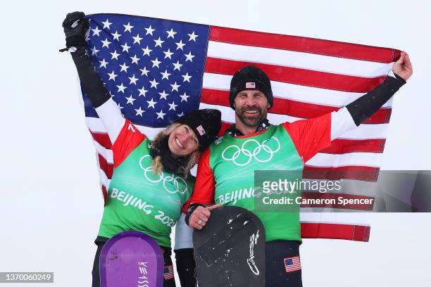 Gold medallists Lindsey Jacobellis and Nick Baumgartner of Team United States celebrate during the Mixed Team Snowboard Cross Finals flower ceremony...