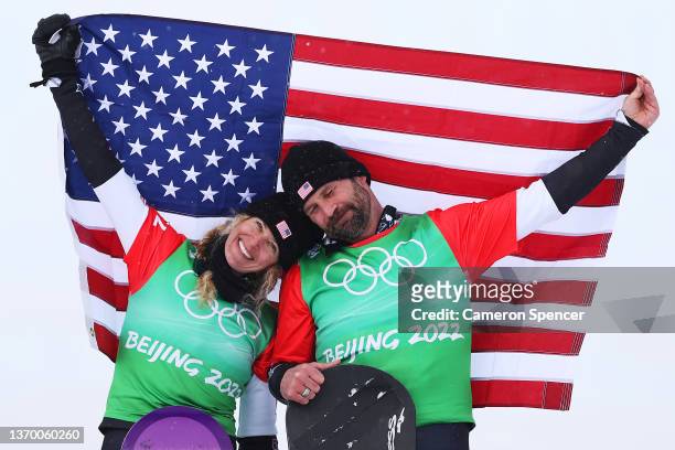 Gold medallists Lindsey Jacobellis and Nick Baumgartner of Team United States celebrate during the Mixed Team Snowboard Cross Finals flower ceremony...