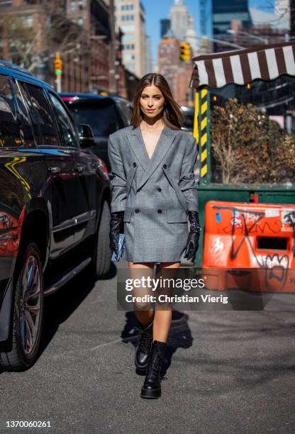 Guest is seen wearing grey blazer, black gloves, Rolex watch outside Bronx & Branco during New York Fashion Week on February 11, 2022 in New York...