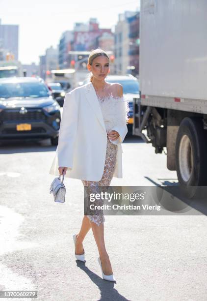 Leonie Hanne seen wearing sheer skirt, white blazer, silver Balenciaga bag, white top outside Bronx & Branco during New York Fashion Week on February...