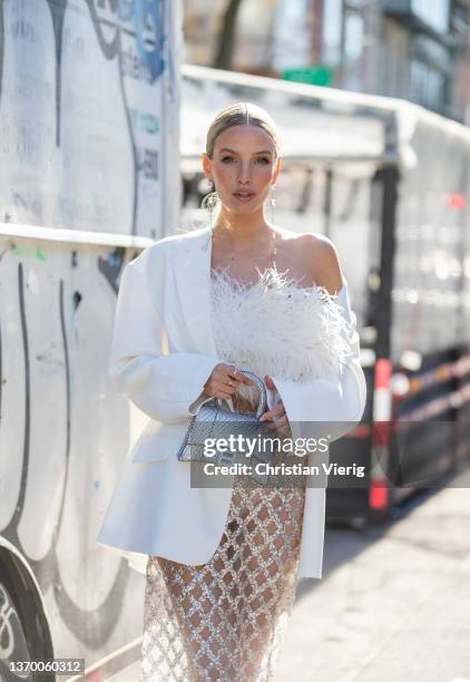 Leonie Hanne seen wearing sheer skirt, white blazer, silver Balenciaga bag, white top outside Bronx & Branco during New York Fashion Week on February...