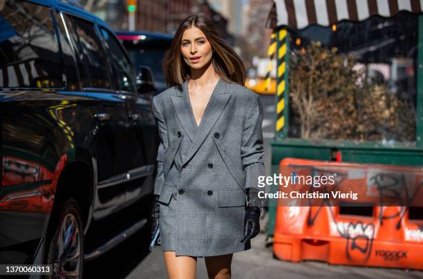 Guest is seen wearing grey blazer, black gloves, Rolex watch outside Bronx & Branco during New York Fashion Week on February 11, 2022 in New York...