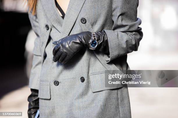 Guest is seen wearing grey blazer, black gloves, Rolex watch outside Bronx & Branco during New York Fashion Week on February 11, 2022 in New York...