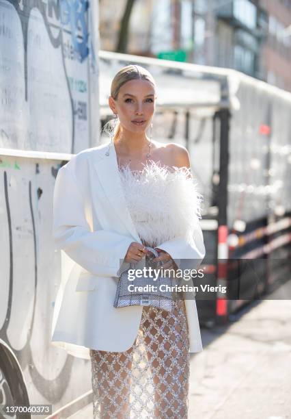 Leonie Hanne seen wearing sheer skirt, white blazer, silver Balenciaga bag, white top outside Bronx & Branco during New York Fashion Week on February...