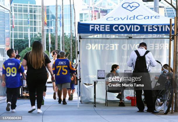 Rams fans walk past free Covid testing outside the Los Angeles Convention Center, site of the Super Bowl Experience, the NFL's 'interactive football...