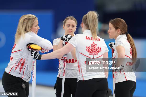 Jennifer Jones, left, Jocelyn Peterman, Dawn McEwen and Kaitlyn Lawes of Team Canada huddle against Team Sweden during the Women's Round Robin...
