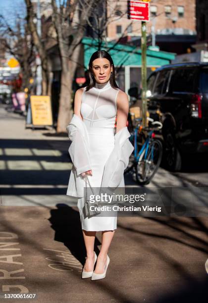 Singer Lea Michele is seen wearing white dress outside Herve Leger during New York Fashion Week on February 11, 2022 in New York City.
