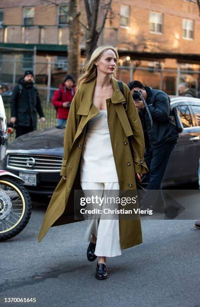 Lauren Santo Domingo seen wearing olive trench coat, white dress, pants outside Proenza Schouler during New York Fashion Week on February 11, 2022 in...