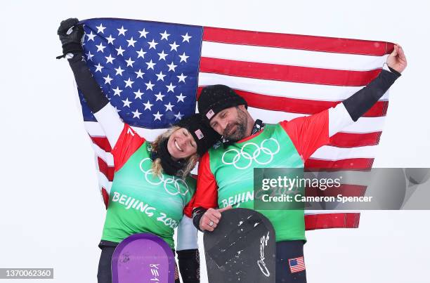 Gold medallists Lindsey Jacobellis and Nick Baumgartner of Team United States celebrate during the Mixed Team Snowboard Cross Finals flower ceremony...