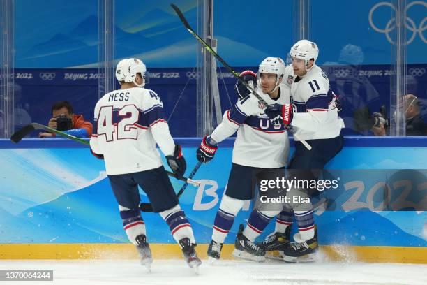 Andy Miele of Team United States celebrates with Aaron Ness and Kenny Agostino after scoring a goal in the first period during the Men's Ice Hockey...