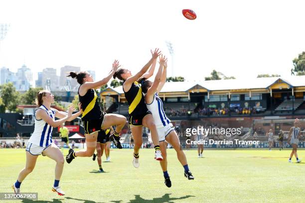 Meagan Kiely of Richmond attempts to mark the ball over Emma Kearney of North Melbourne during the round six AFLW match between the Richmond Tigers...