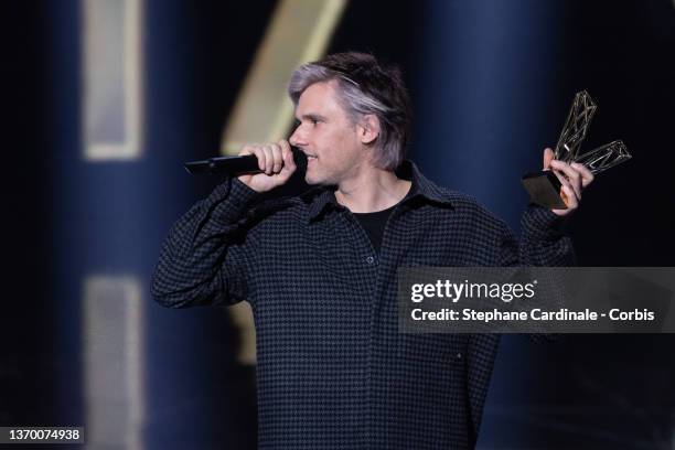 Aurelien Cotentin aka Orelsan reacts after receiving the Best Original Song award for "L'odeur de l'essence" during the 37th Victoires de la Musique...