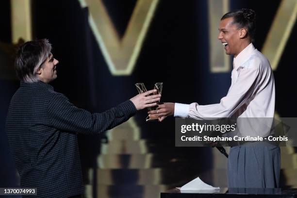 Aurelien Cotentin aka Orelsan receives the Best Male Artist award from Belgian singer and president of honor Paul Van Haver aka Stromae during the...