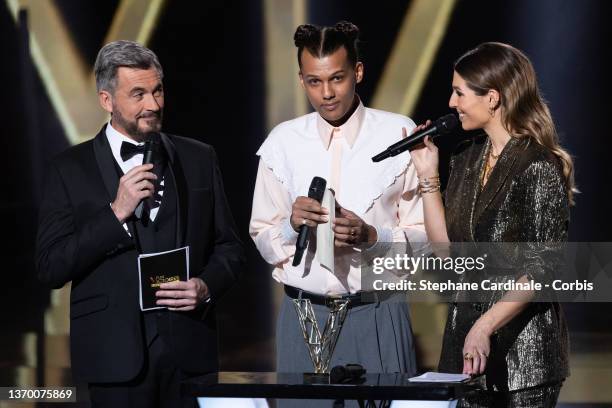 Olivier Minne, Stromae and Laury Thilleman on stage during the 37th Victoires de la Musique at La Seine Musicale on February 11, 2022 in...