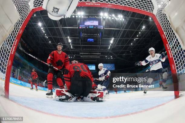 Andy Miele and Brian Oneill of Team United States react after a goal by Kenny Agostino as goaltender Eddie Pasquale and Alex Grant of Team Canada...