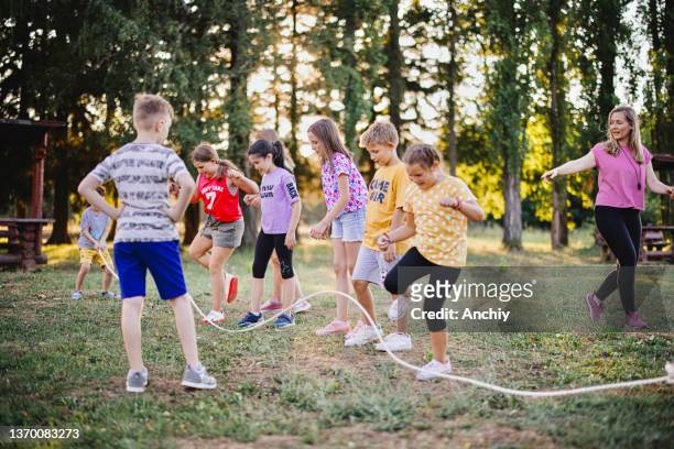school children jumping rope in a summer camp - jumping rope stock pictures, royalty-free photos & images