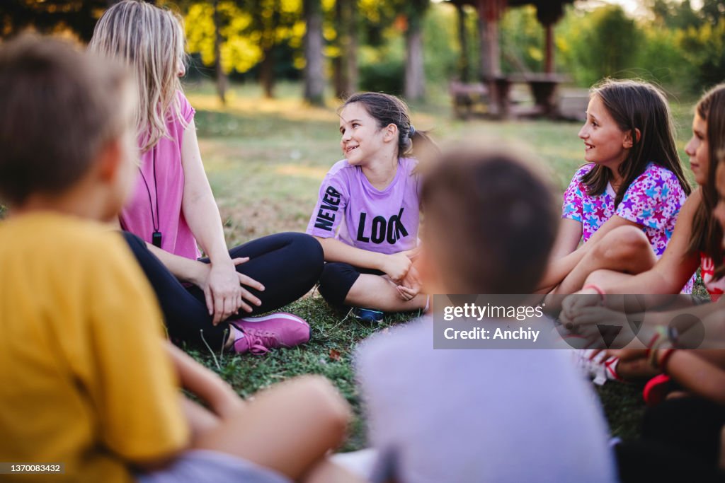 School children learning about ecology, nature and environment with teacher