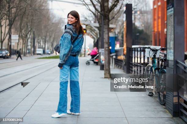 Model Mathilde Henning wears a denim total look - a denim jacket and denim two-tone jeans outside the Alexandre Vauthier show on January 25, 2022 in...