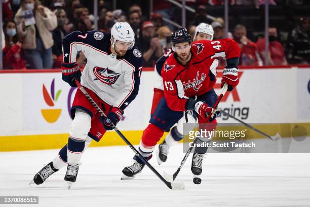 Sean Kuraly of the Columbus Blue Jackets and Tom Wilson of the Washington Capitals skate for the puck during the third period of the game at Capital...