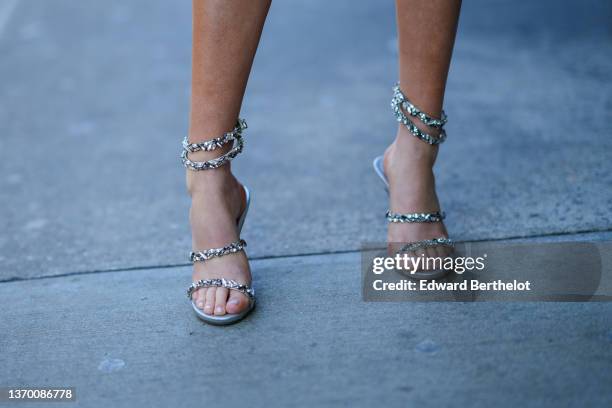 Guest wears silver leather and embroidered rhinestones strappy ankle pumps heels sandals, outside Bronx And Banco, during New York Fashion Week, on...