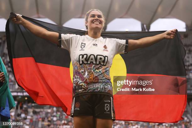 Tommaya Kelly-Sines of the Indigenous Women's All Stars celebrates victory with the a flag during the match between the Women's Indigenous All Stars...