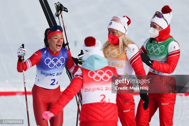 Veronika Stepanova of Team ROC celebrates with teammates after winning the gold medal during the Women's Cross-Country 4x5km Relay on Day 8 of the...