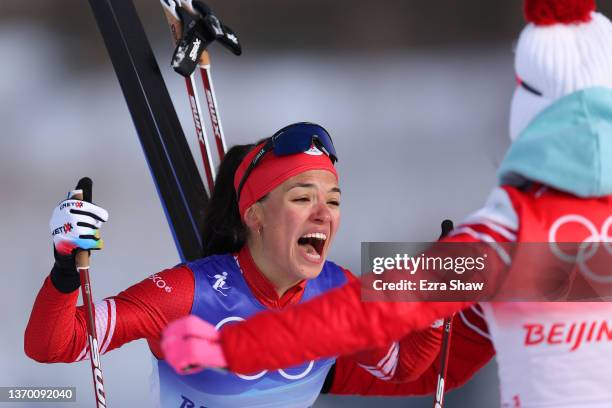 Veronika Stepanova of Team ROC celebrates winning the gold medal after crossing the finish line during the Women's Cross-Country 4x5km Relay on Day 8...