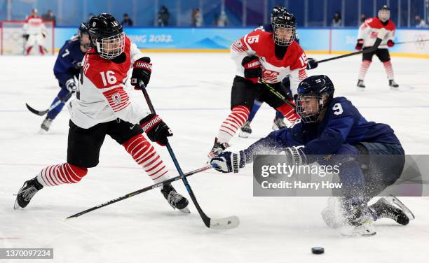 Nelli Laitinen of Team Finland challenges Akane Shiga of Team Japan in the first period during the Women's Ice Hockey Quarterfinal match between Team...