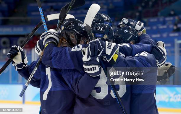 Michelle Karvinen of Team Finland celebrate with team mates after scoring the third goal against Team Japan in the second period during the Women's...