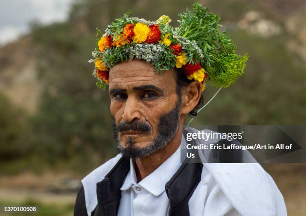 Portrait of a flower man with a floral crown on the head and kohl on his eyes, Asir province, Sarat Abidah, Saudi Arabia on January 2, 2022 in Sarat...