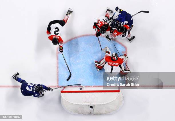Michelle Karvinen of Team Finland is scoring the third goal against Nana Fujimoto, goaltender of Team Japan in the second period during the Women's...