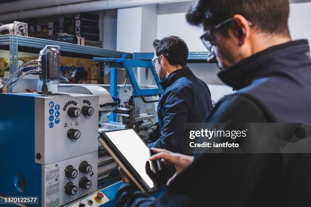 mechanical technicians operative of cnc milling cutting machine center at tool workshop. - milling machine stock pictures, royalty-free photos & images