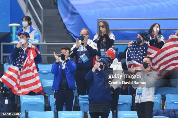 Shaun White of Team United States and team members cheer from the stands during the Ice Dance Rhythm Dance on day eight of the Beijing 2022 Winter...