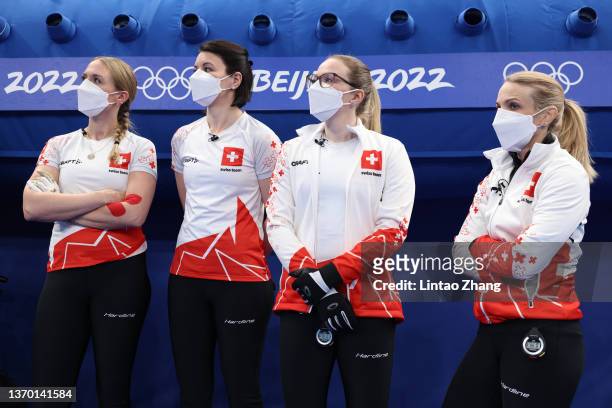Alina Paetz, Silvana Tirinzoni, Esther Neuenschwander and Melanie Barbezat of Team Switzerland look on during the Women's Round Robin Curling Session...