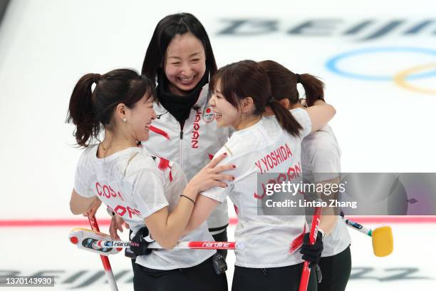 Satsuki Fujisawa, Chinami Yoshida, Yumi Suzuki and Yurika Yoshida of Team Japan celebrate following victory against Team ROC the Women's Round Robin...