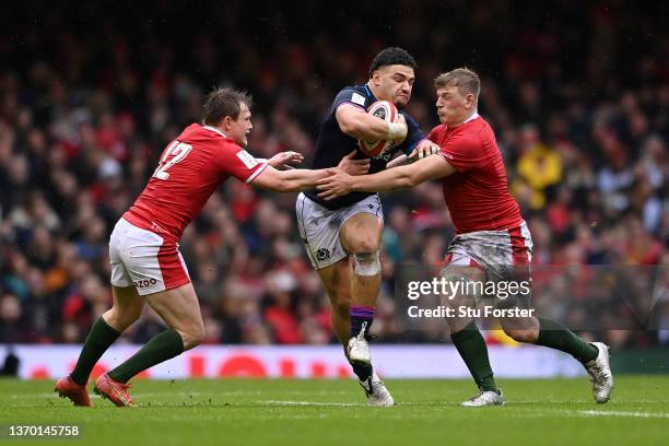 Sione Tuipulotu of Scotland is battles with Nick Tompkins and Jac Morgan of Wales during the Guinness Six Nations match between Wales and Scotland at...