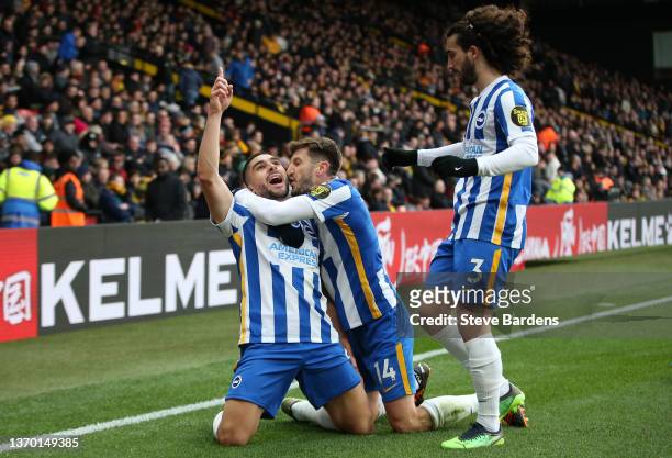 Neal Maupay celebrates with teammates Adam Lallana and Marc Cucurella of Brighton & Hove Albion after scoring their team's first goal during the...