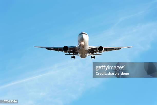 xl jet airplane landing in bright sky - plane front view stock pictures, royalty-free photos & images