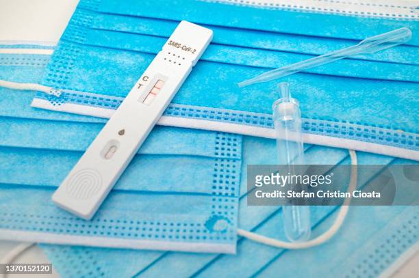 positive test for covid19 over face protective masks - coronavirus romania stock pictures, royalty-free photos & images